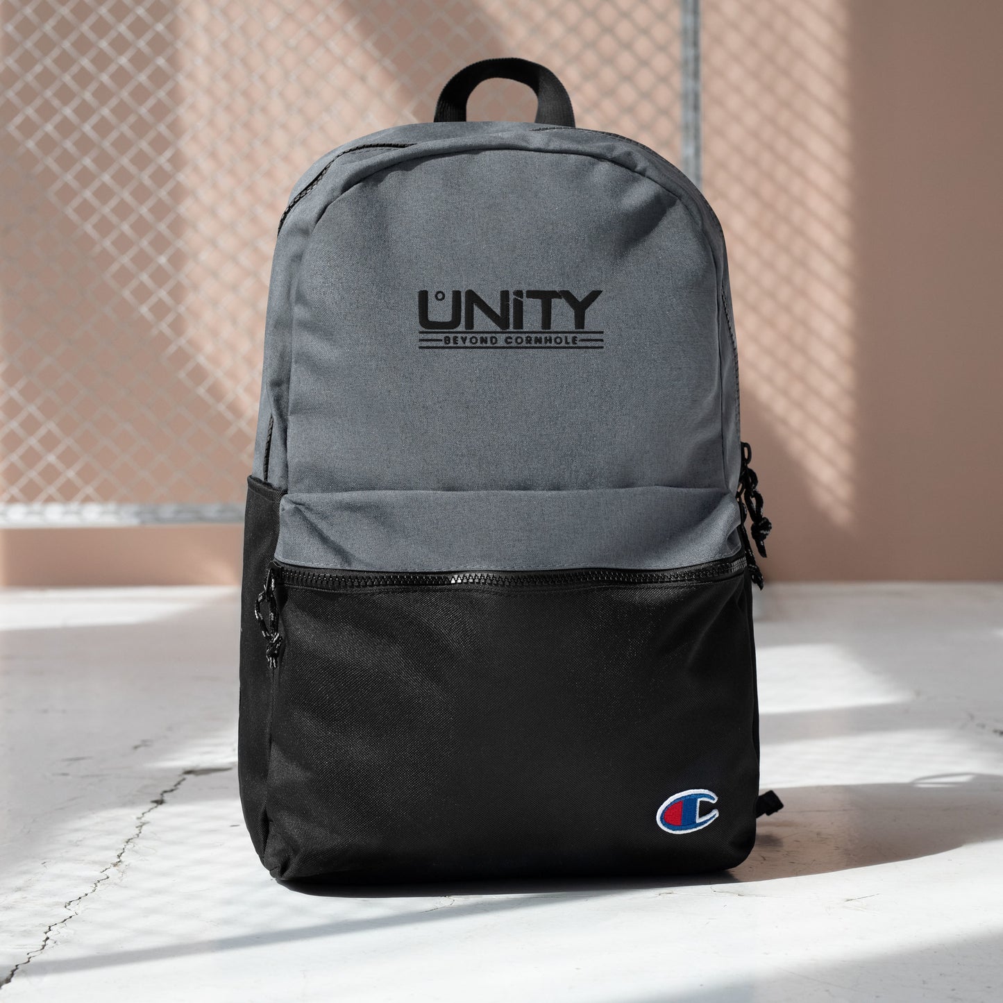 Unity Beyond Cornhole Embroidered Champion Backpack